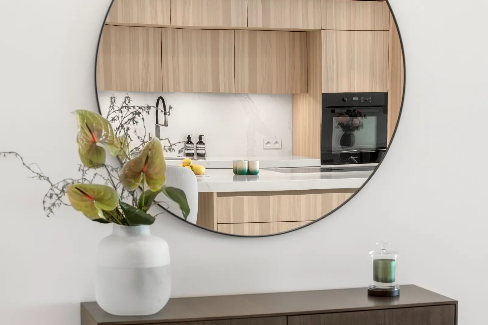 Miroir rond reflétant la cuisine rénovée